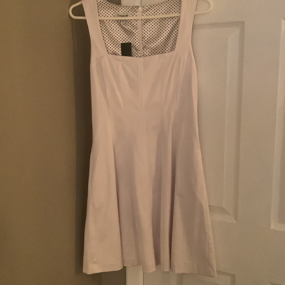 NWT, Bebe white A-line dress size medium. Zips up back, sleeveless